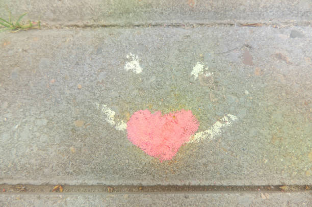 istock painted face with heart on the pavement 1292330343