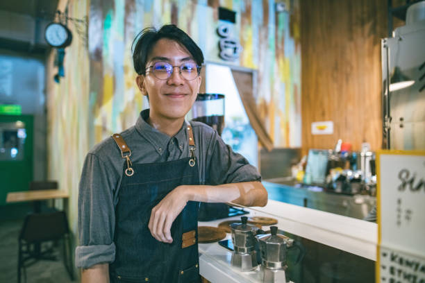 istock Asian cafe working smiling to the camera in cafe 1292332734
