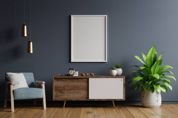 istock Poster mockup with vertical frames on empty dark wall in living room interior with blue velvet armchair. 1292333418