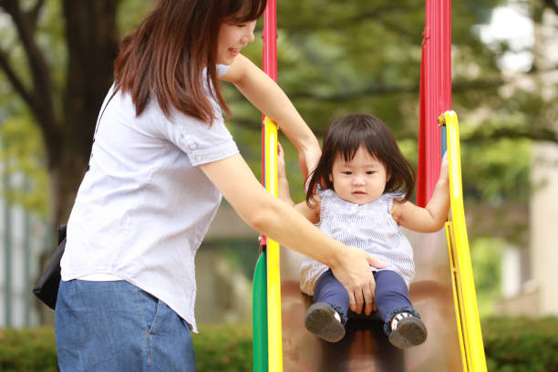 istock Parents and children playing on the slide 1292340375