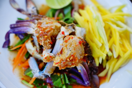 Close​-up​ to​ pickled​ sea crab​​ with​ herbs​ chili​ garlic​ lemon