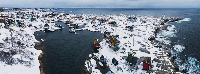 Aerial drone view of the iconic fishing village of Peggy's Cove covered with fresh snow.