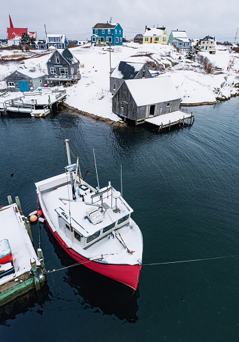 Aerial drone view of the iconic fishing village of Peggy's Cove covered with fresh snow.
