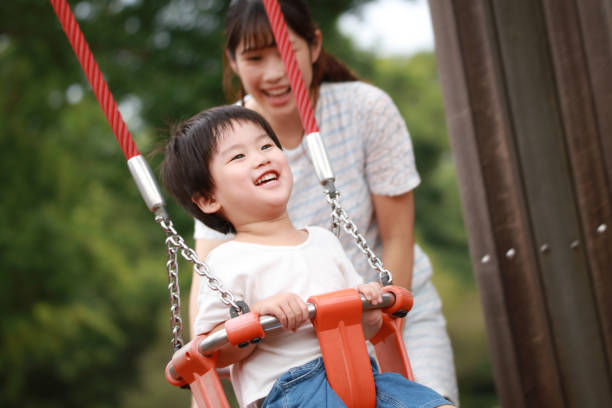 istock Parents and children playing on a swing 1292343775