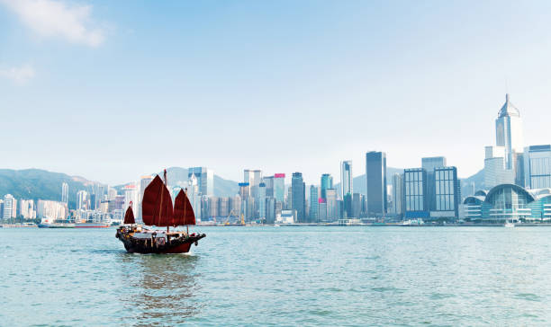 istock Junk boat crossing Hong Kong harbor 1292343894