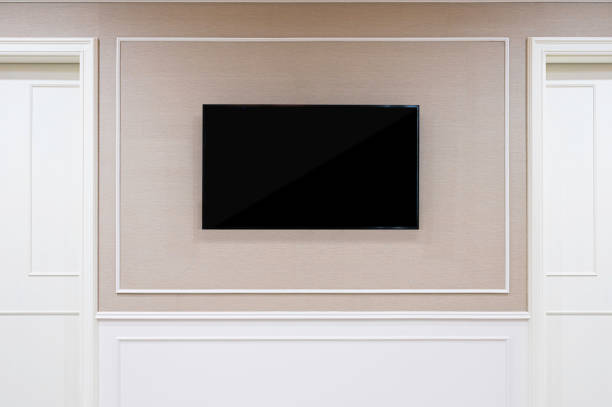 istock Smart TV Mockup with blank screen hanging on wall background. Clipping path included 1292346798