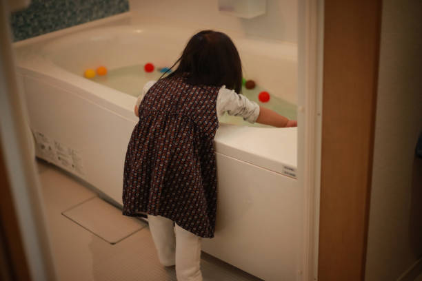 istock Girl looking into the bathtub 1292347555