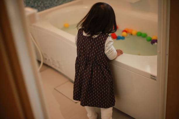 istock Girl looking into the bathtub 1292347612