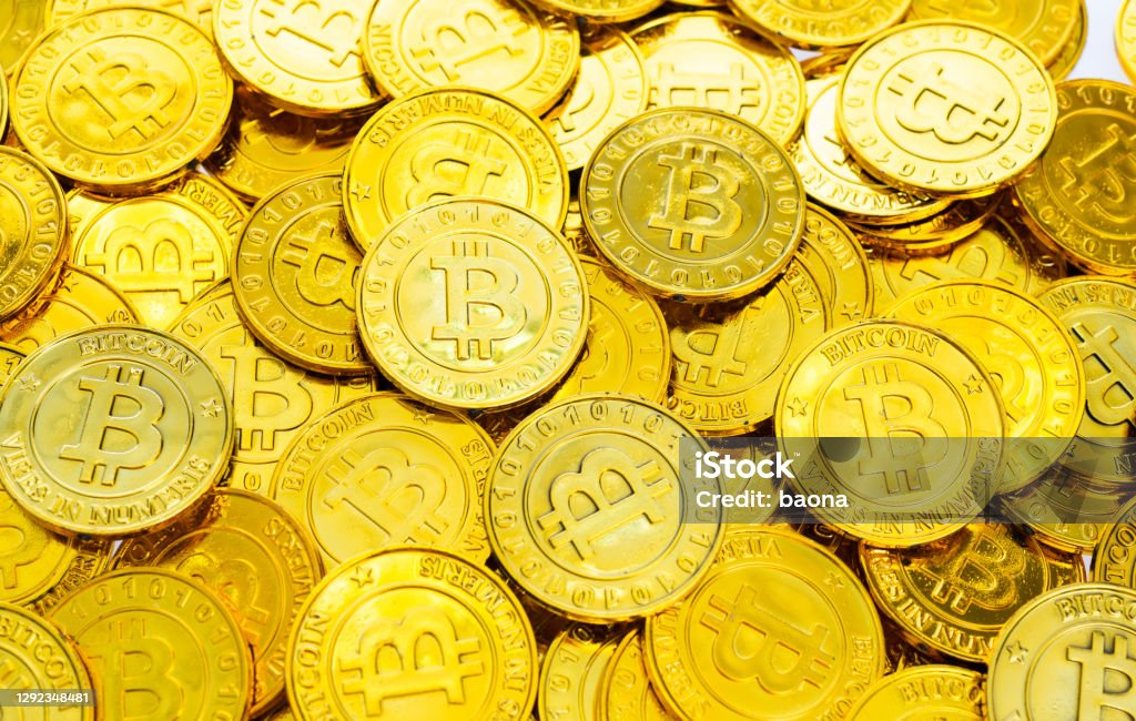 Heap of golden bitcoins background Fujian, China - November 15, 2018: Bunch of memorial golden bitcoins. Bitcoin is a worldwide digital currency that isn't controlled by a central authority such as a government or bank. Bitcoin Stock Photo