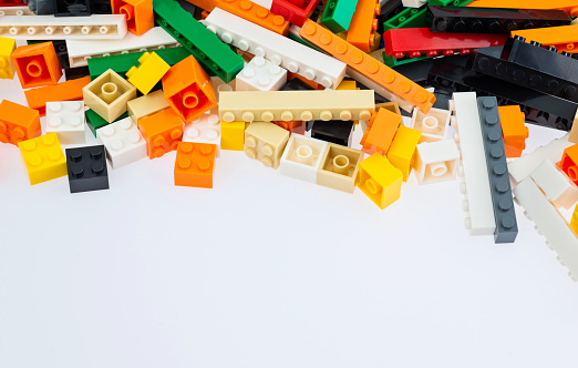 Heap of plastic blocks on white background.