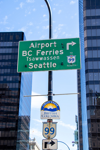 Vancouver, Canada - June 29,2020: View of the road sign with directional arrow points to Airport, Tsawwassen, Seattle in downtown Vancouver