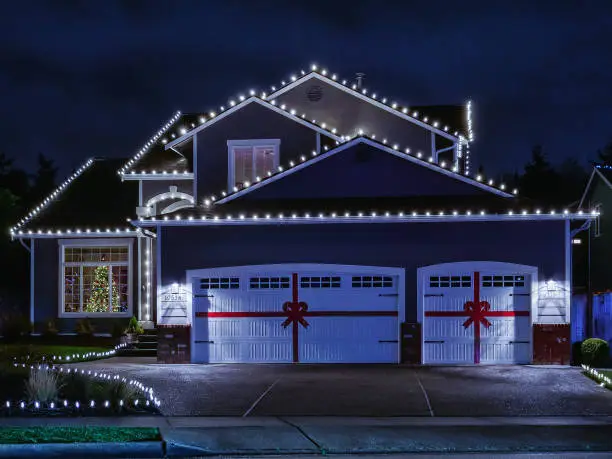 Photo of American suburban home exterior with festive Christmas lights