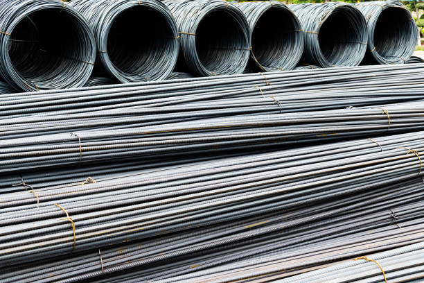 Steel wire rolls and steel bars on construction site.