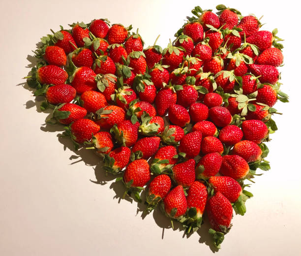 istock Fresh strawberry in heart shape flat lay 1292355719