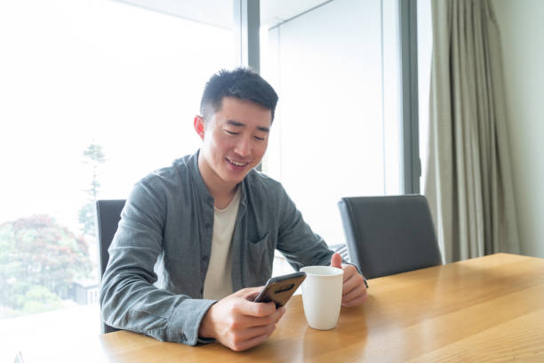 istock Young Asian man using phone with a positive facial expression using phone 1292358199