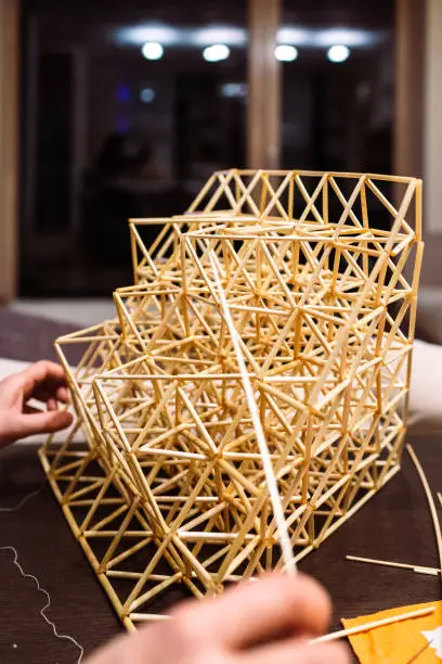 Process of making a traditional Finnish decoration - Himmeli, made from natural straws.