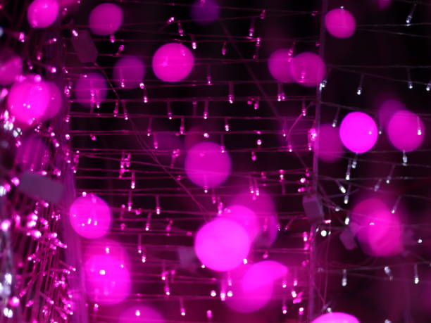 istock Abstract Bokeh light blurred background, lightbulb on Christmas tree for celebrate season with pink, purple and white colorful defocus circle for background invitation card. Multi-color rainbow bokeh. 1292359068