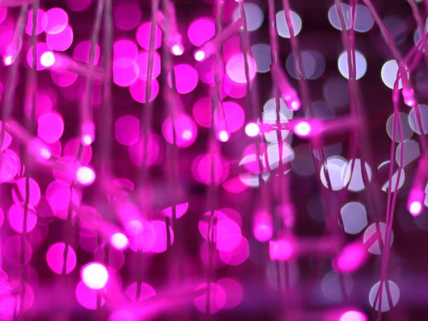 istock Abstract Bokeh light blurred background, lightbulb on Christmas tree for celebrate season with pink, purple and white colorful defocus circle for background invitation card. Multi-color rainbow bokeh. 1292359119