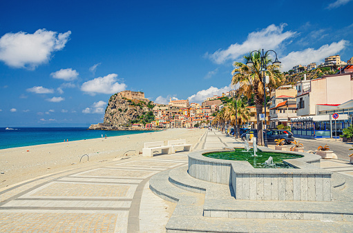 Cityscape of Scilla town with embankment promenade of Mediterranean Tyrrhenian sea coast, old medieval castle Castello Ruffo on rock and colorful traditional italian houses, Calabria, Southern Italy