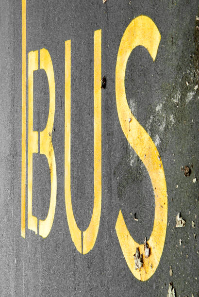 istock Bus line on an asphalt road. Yellow text on the road. 1292360460