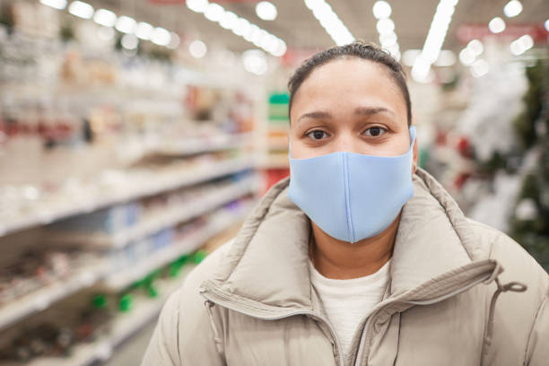 istock Woman in mask in the store 1292361612