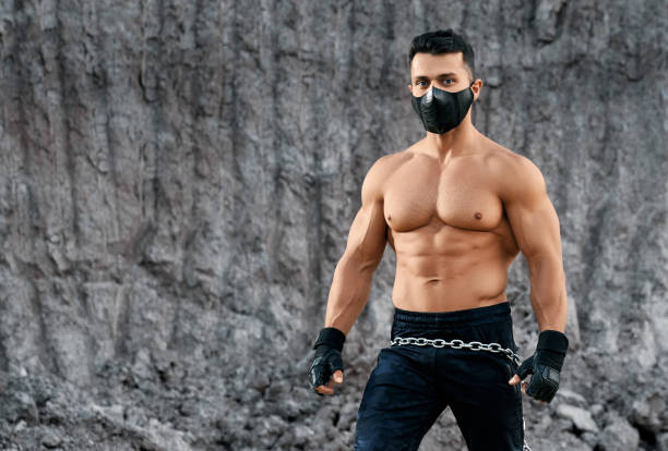 istock Strong man with naked torso posing among sand quarry 1292361890