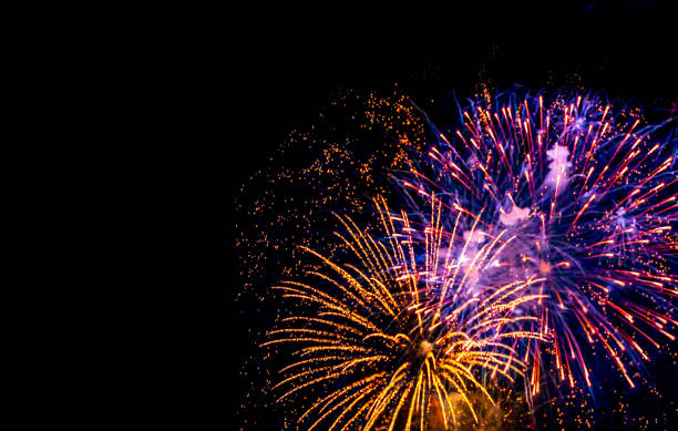istock Holiday Fireworks at New Year Eve. Abstract Festive background with fireworks sparkles. Copyspace