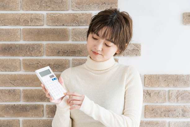 istock young woman with a calculator 1292363147