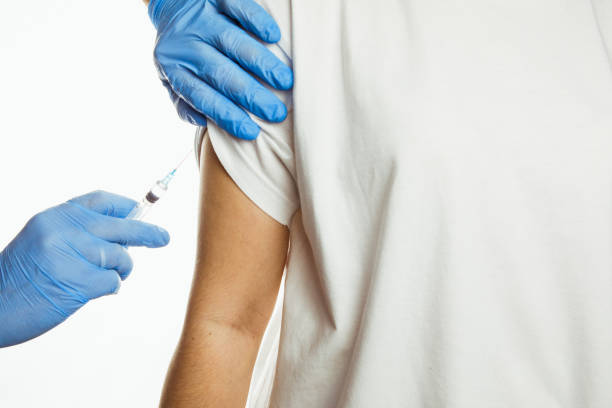 istock making injection of vaccine in shoulder white background 1292364788