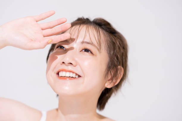 istock Young Asian woman blocking the bright sunlight 1292365555