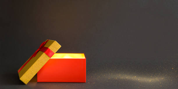 istock Open red gift box with a bow with a golden glow and glitter inside on a black background, banner, copyspace. universal holiday, christmas, valentine's day, new year, birthday, black friday 1292365613