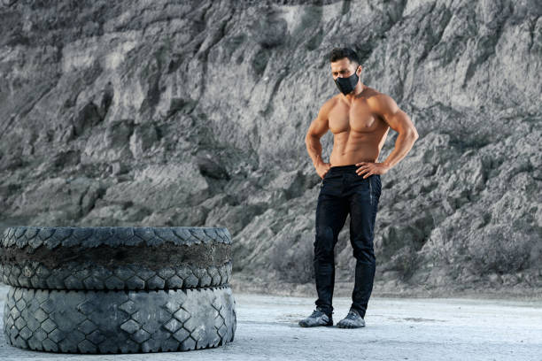 istock Handsome sportsman in black mask enjoying outdoors training 1292365709