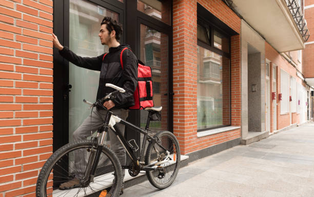 istock Courier to deliver food at building site with bicycle 1292365883