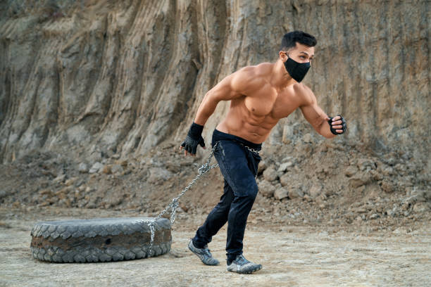 istock Muscular man exercising outdoors with tyres 1292365940