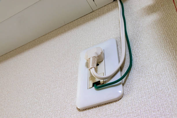 istock Power plug and ground wire connected to electrical outlet on the wall 1292366586