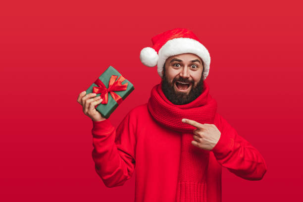 istock Amazed bearded man demonstrating Xmas gift box 1292366915