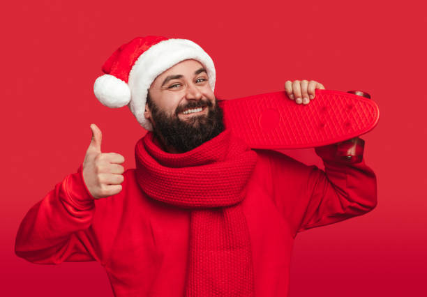 istock Cheerful man with skateboard enjoying Christmas holidays 1292366920