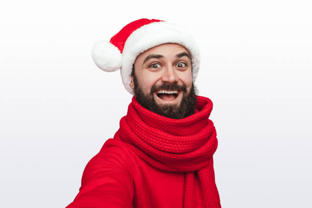 istock Excited man in Santa hat looking at camera 1292366922