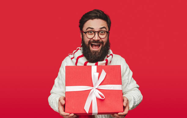 istock Surprised man with big Christmas gift box 1292366937