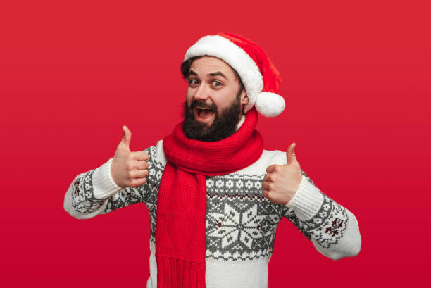 istock Happy man in Santa hat gesturing thumbs up 1292366941