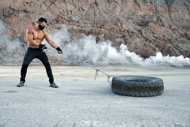istock Man with athletic body training arms at sand pit 1292367673