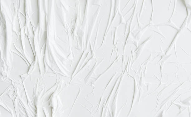 istock Wall white paper with air pockets. White uneven wrinkled textured background. 1292368083