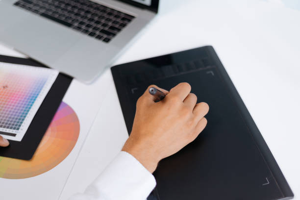 istock male designer using a graphic tablet to work with the color palette 1292368879