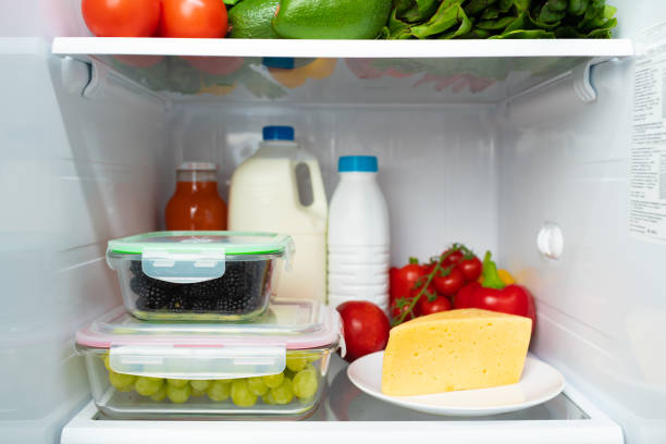 istock Open fridge full of fruits, vegetables and drinks 1292372096