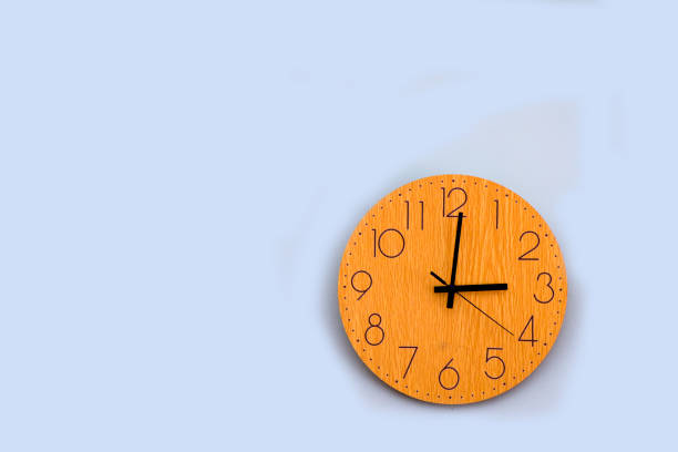 istock Wooden clock on the green wall, numbers and time 1292372803