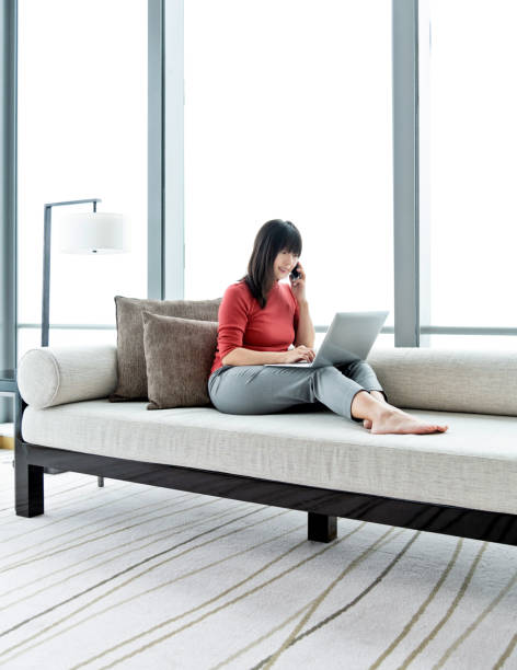 istock Woman sitting on sofa and using mobile phone 1292373085
