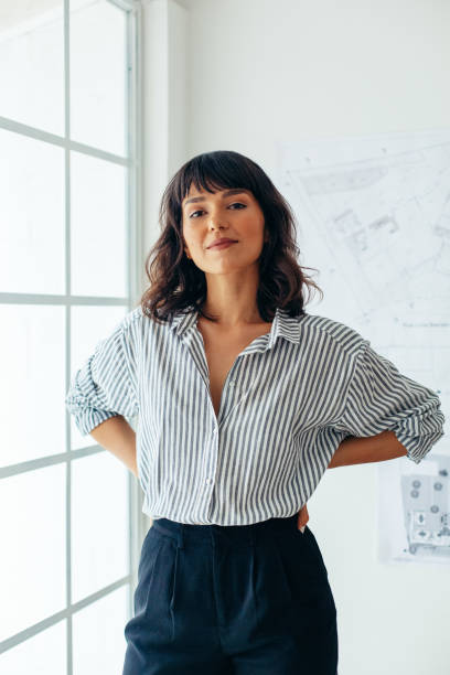 istock Confident businesswoman standing in office 1292373291