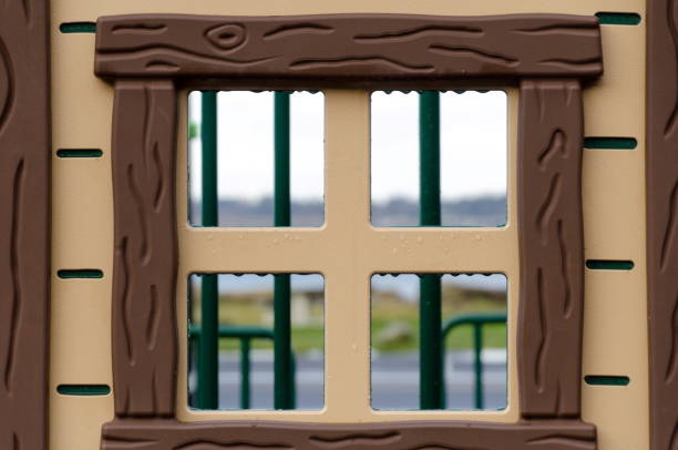 Looking through plastic window at playground in Birch Bay park at White Rock shoreline