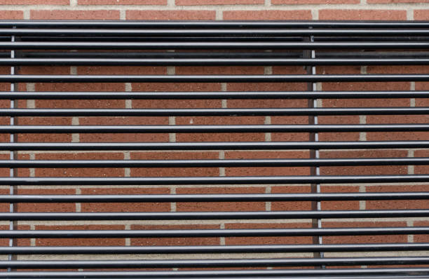 Grid made by brick wall and a bench back at Harris Street in Bellingham, Washington