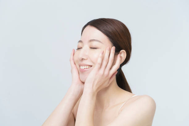 istock Asian woman touching her face 1292375686